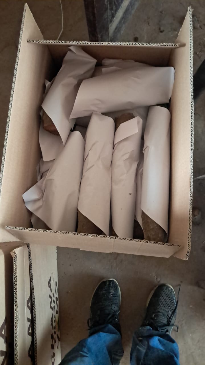 Yams paper-wrapped inside a Ghana Fresh Yams export carton